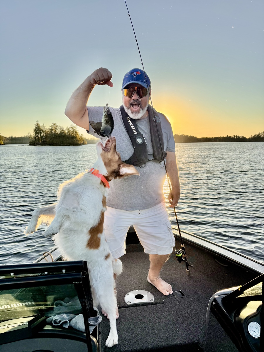 First place this year is awarded to SAMANTHA CIRINNA for this great fun shot, aptly titled “My husband Frank and Jack the dog.  No one loves fishing more than these two.”  It is hard to tell which one is having more fun.